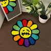 A colorful, embroidered sunflower design on a black mat, used as a non-slip bathroom mat.