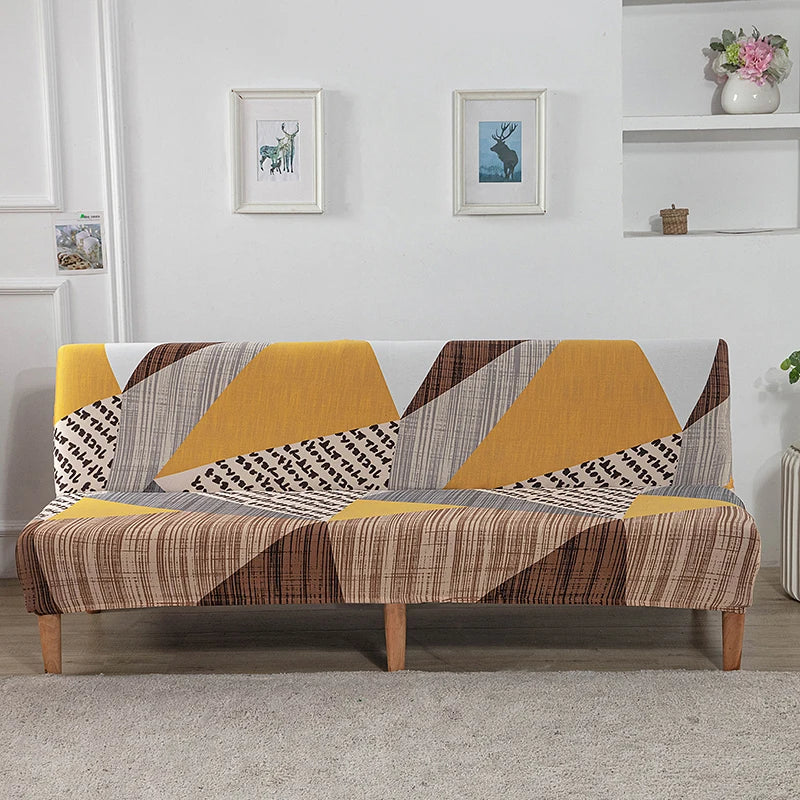 A sofa bed with geometric print spandex slipcovers featuring yellow, gray, and brown patterns.