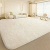A plush, long-pile white area rug is displayed on a light wood floor in a modern, bright room.