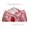 A pink bedding set featuring a floral pattern with red roses and white accents, including two pillowcases and one duvet cover