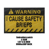 Black embroidered patch with yellow text warning I CAUSE SAFETY BRIEFS