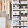 A white shelving unit organizes various colored bed sheets and linens using elastic straps.