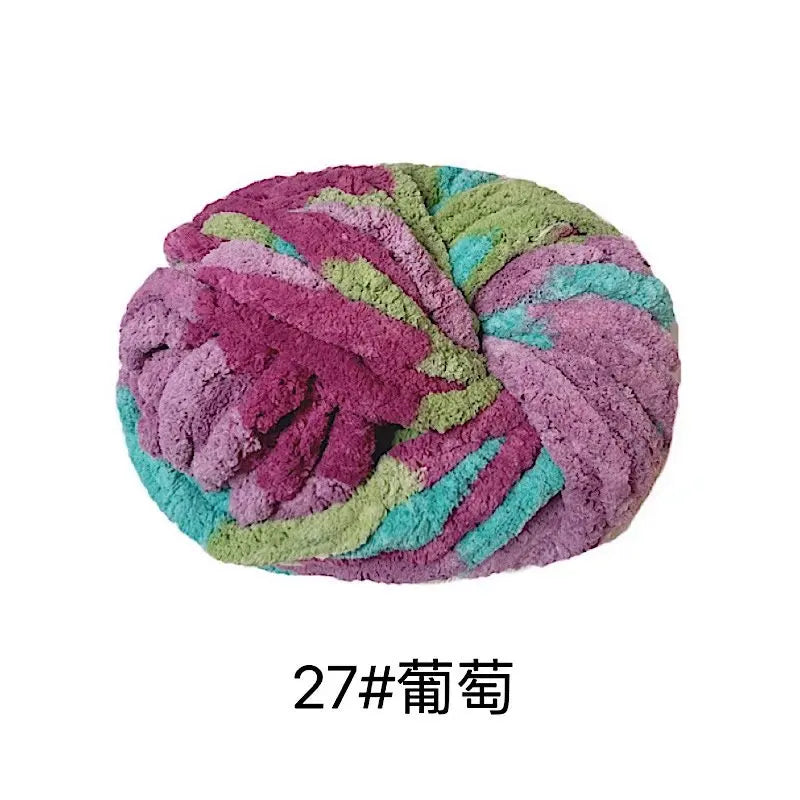 A ball of purple and green chunky acrylic yarn for knitting and crochet projects.
