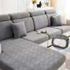 Gray jacquard plush sofa cushion covers with matching pillows and a coffee cup on a light-colored sofa.
