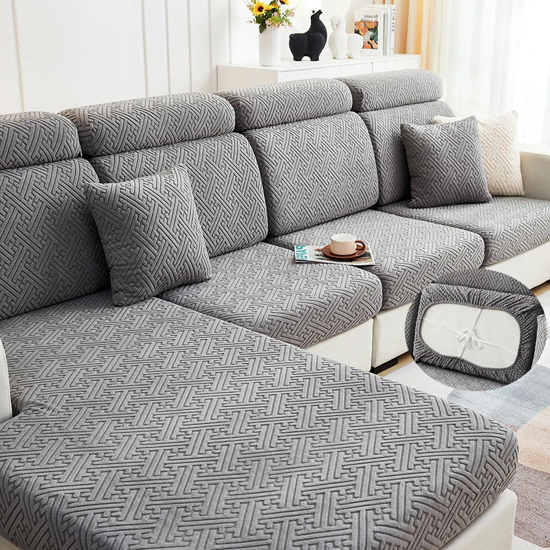 Gray jacquard plush sofa cushion covers with matching pillows and a coffee cup on a light-colored sofa.