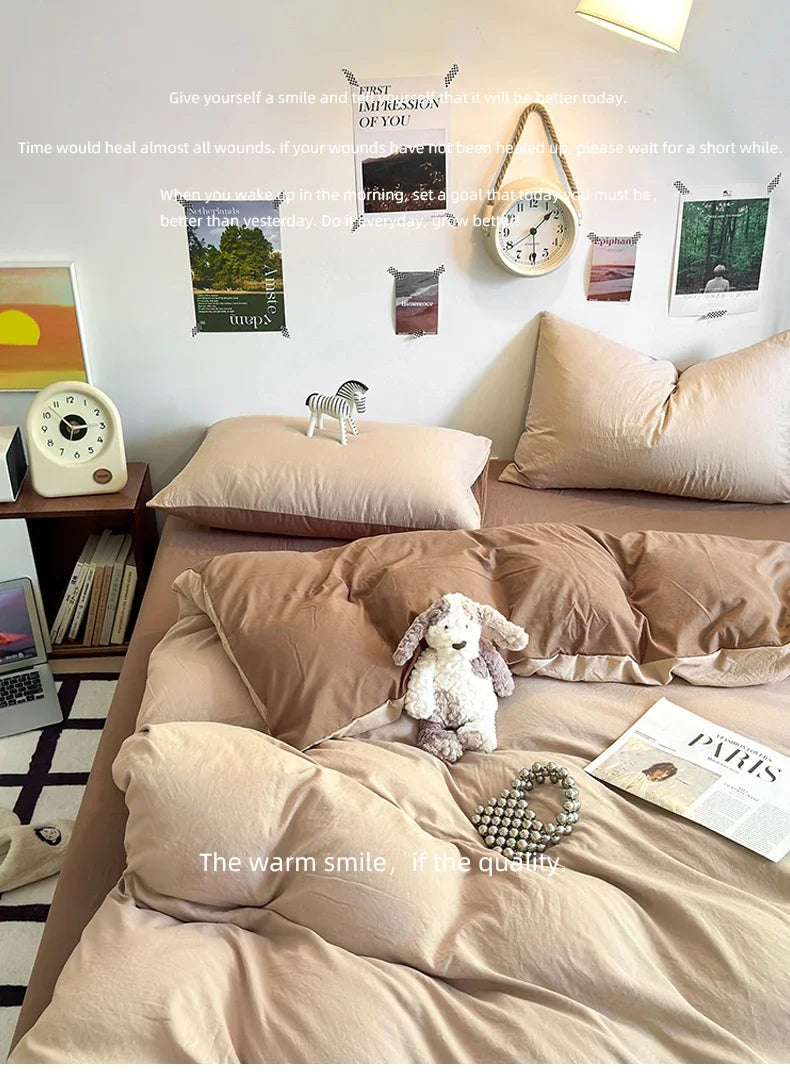 A bed with beige bedding and pillows, featuring inspirational quotes on the wall.