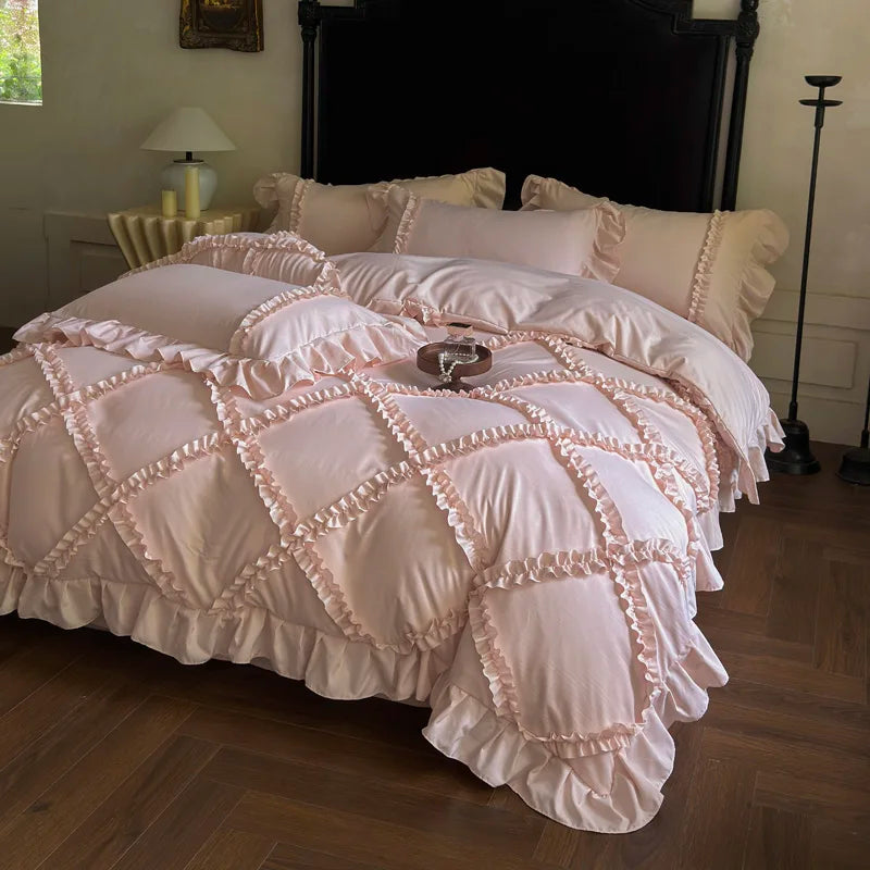 A pink ruffled duvet cover set with quilted detailing is displayed on a bed.