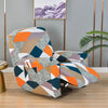 A modern recliner chair upholstered in a geometric pattern of gray, orange, navy blue, and beige fabric.