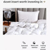 White duvet insert and pillows displayed on a bed, emphasizing quality and warmth.