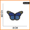 A set of five embroidered butterfly and rose iron-on patches with blue wings and yellow accents.