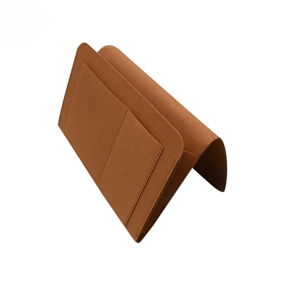 A brown felt bedside storage organizer with a hanging pocket shown at an angle.