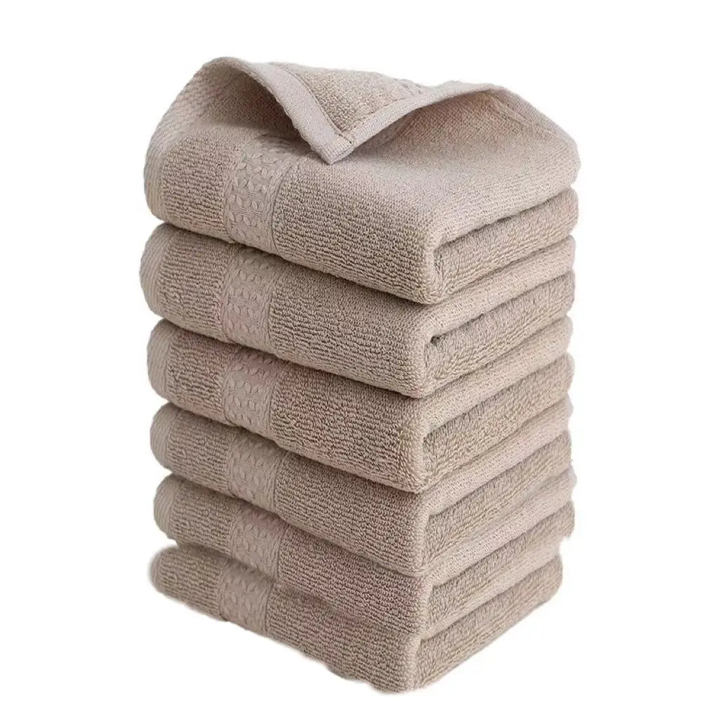 A stack of six beige or light brown knitted face towels