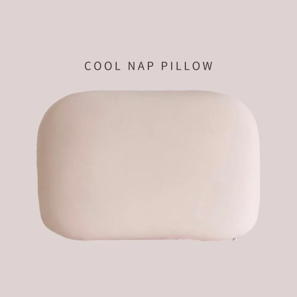 A soft, oval-shaped, light beige memory foam neck and travel pillow.