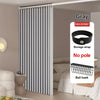 Gray heavy duty foldable room divider curtain with storage strap and ball hook shown in a bedroom setting