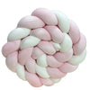 Handmade knotted floor mat for bed decor made of pink and white fluffy yarn.
