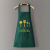 A dark green waterproof oil-proof PVC kitchen apron hanging on a wooden hanger.