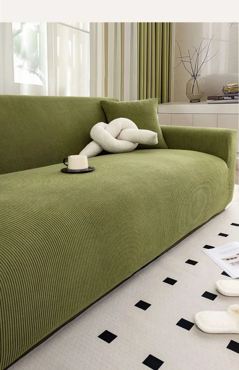 A lime green stretch jacquard sofa slipcover in a modern living room setting.