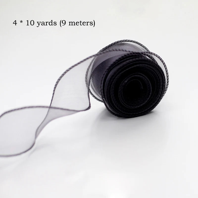 A roll of sheer black silky organza ribbon, measuring 4 by 10 yards (9 meters).
