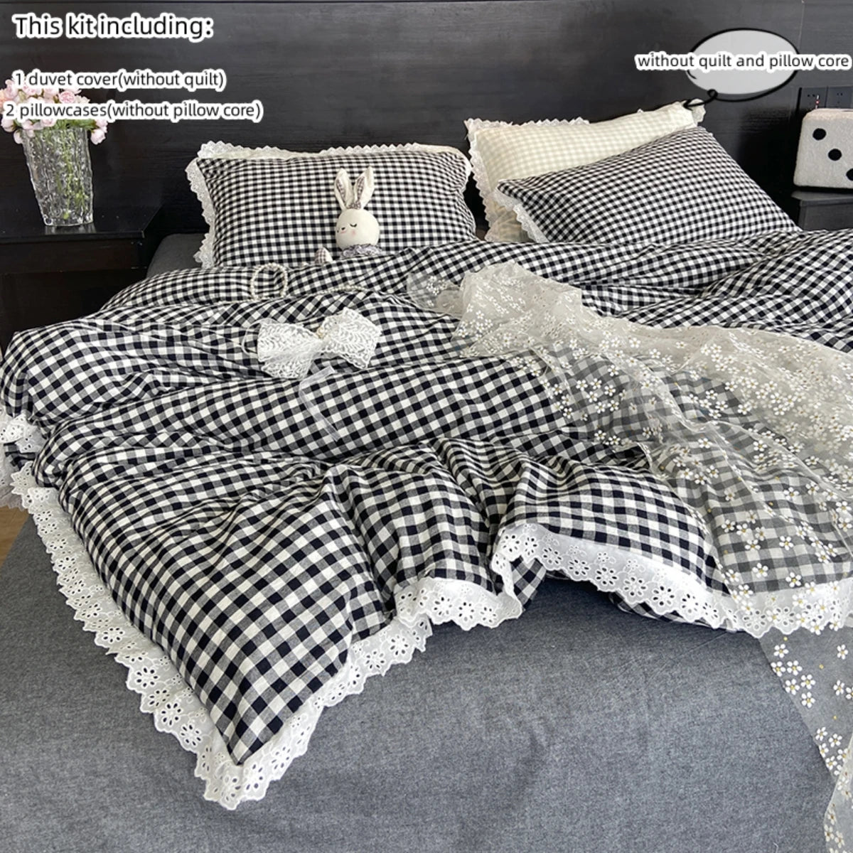 A plaid duvet cover and pillowcase set featuring black and white checkered fabric with lace trim.