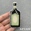 An embroidered iron-on patch shaped like a glass bottle with a green liquid and black and white detailing.