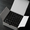 A white box containing 144 small, clear embroidery bobbin threads arranged in a grid.