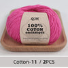 Pink organic cotton yarn skein with a label showing environmental protection dyeing details