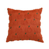 An orange textured throw pillow cover with a repeating pattern of small green pumpkin shapes.