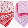 A collection of pink, red, and white floral dot pattern cotton fabric squares for DIY crafting.
