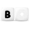 A white silicone alphabet bead with the letter B and a circular hole.