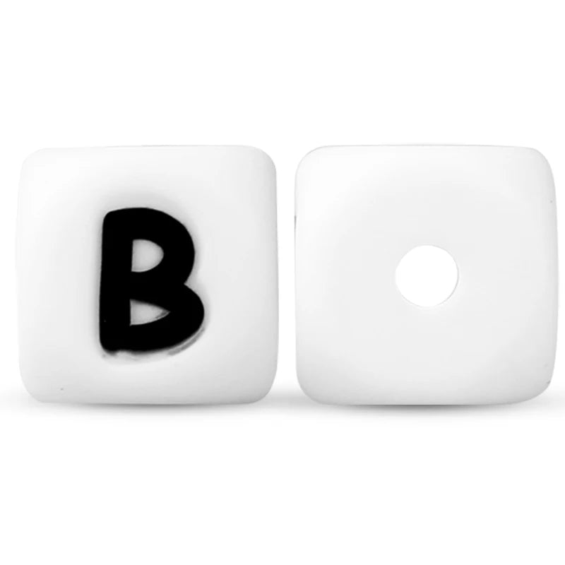 A white silicone alphabet bead with the letter B and a circular hole.