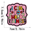 Pink embroidered patch with the text I CAN DO HARD THINGS in black and red thread.
