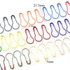 A collection of colorful safety bulb pins for knitting and sewing in various sizes and colors.