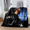 A black flannel blanket featuring a graphic design of a person playing a guitar.