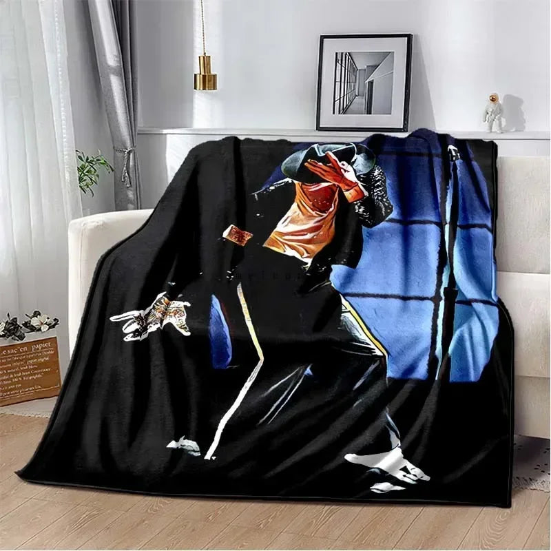 A black flannel blanket featuring a graphic design of a person playing a guitar.
