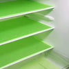 A set of four bright green, non-slip shelf liners for a refrigerator or freezer.