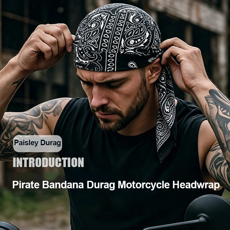 A man is adjusting a black paisley bandana durag headwrap for motorcycle riding.