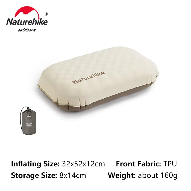 A beige inflatable camping pillow with a gray fabric tag and specifications visible.