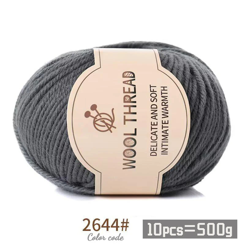 Gray wool thread skein with a label indicating delicate and soft intimate warmth