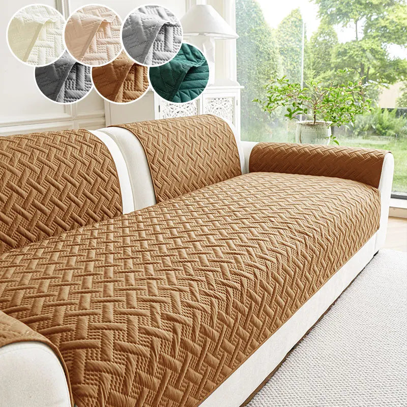 A textured, quilted brown sofa cushion with white trim is shown on a light-colored sofa.