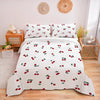 White duvet cover set with a red fruit print featuring cherries and leaves on a bed.