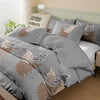 Gray duvet cover set featuring a floral plant print with bronze and white accents on a bed.