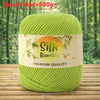 A ball of bright lime green silk bamboo blend yarn labeled Premium Quality