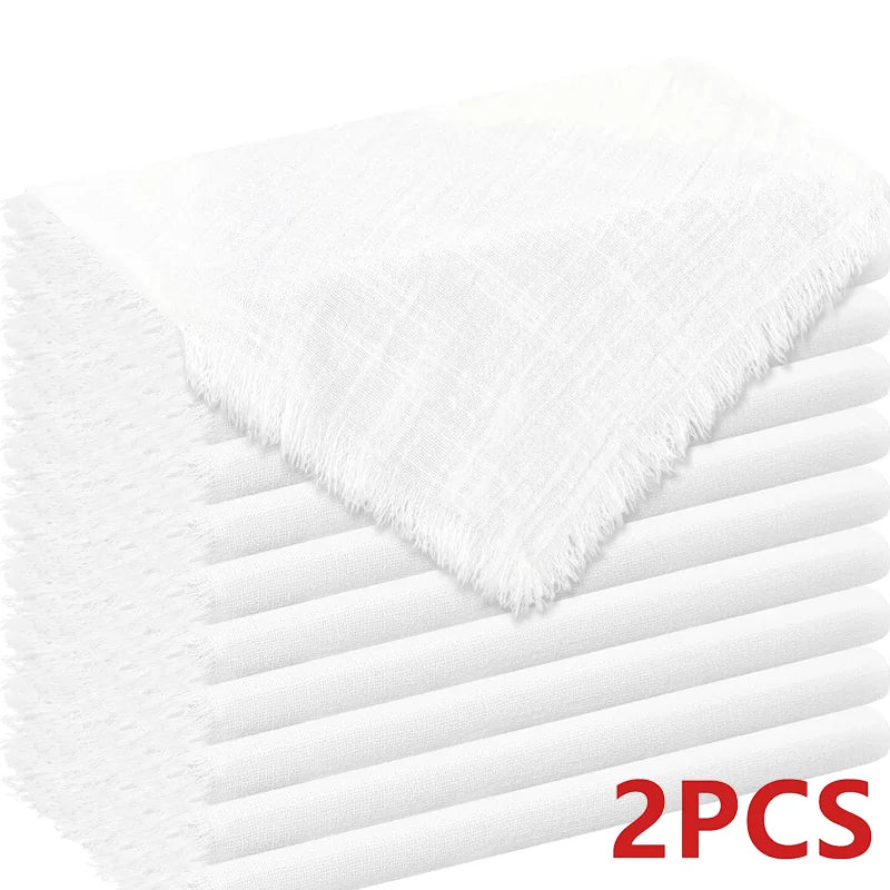 A stack of two white decorative cloth napkins shown from above.