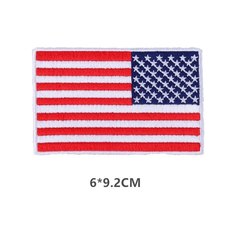 A rectangular embroidered USA flag patch featuring red and white stripes and a blue field with white stars.