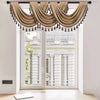A beige European style window curtain valance with tassels hanging over a white door frame.