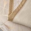 A close-up of a beige luxury chenille sofa cover featuring gold geometric stitching and tan piping.
