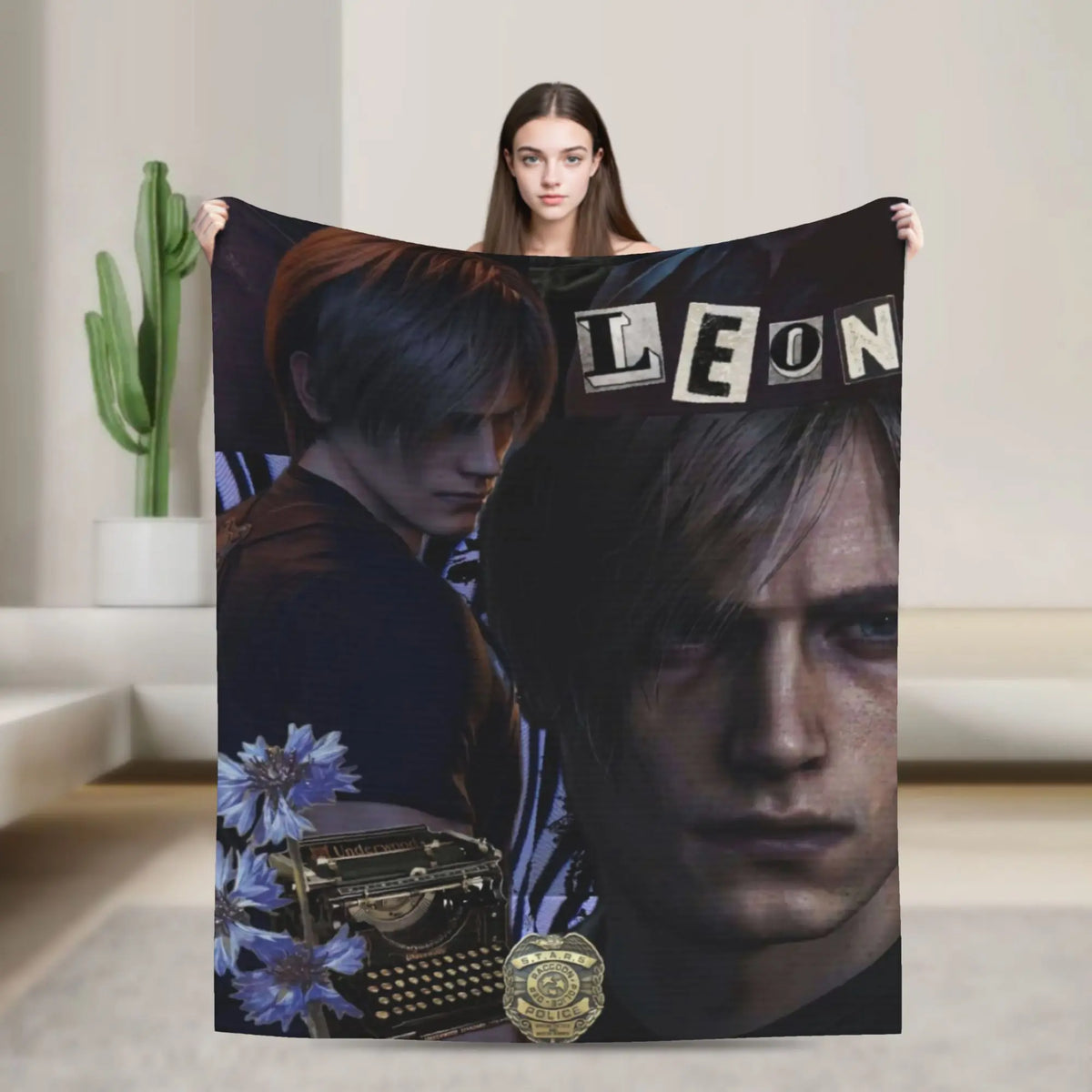 A person holds up a dark graphic throw blanket featuring a close-up portrait of a man.
