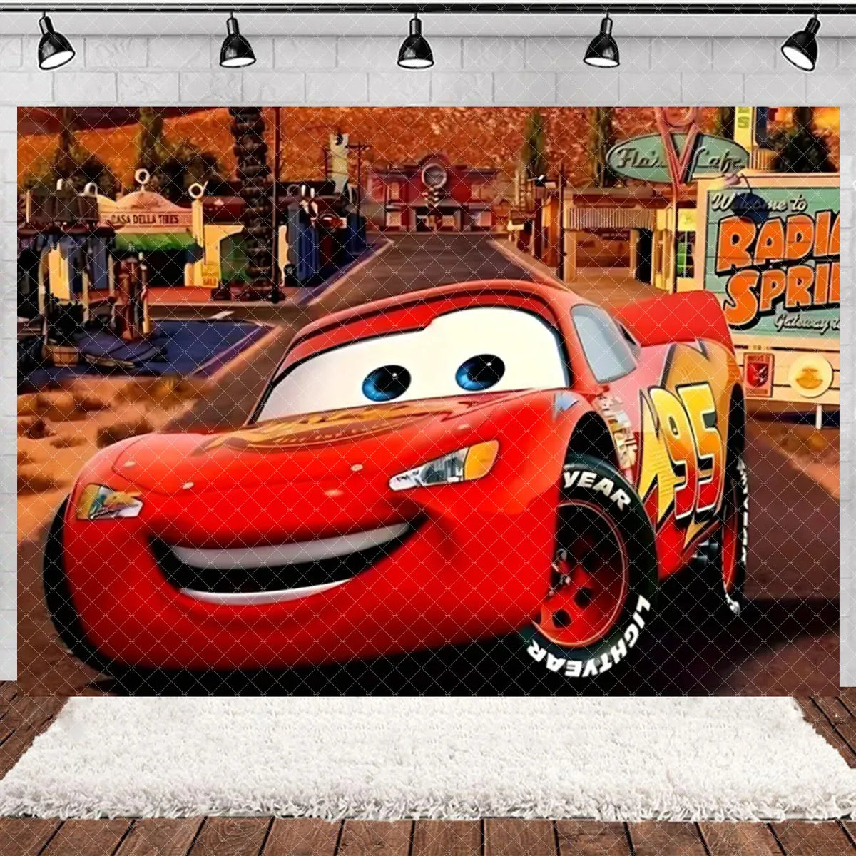 A red cartoon race car is featured in a backdrop setting with a brick wall and street scene.