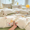 A beige duvet set featuring a cute dog print with floral patterns, displayed on a bed.