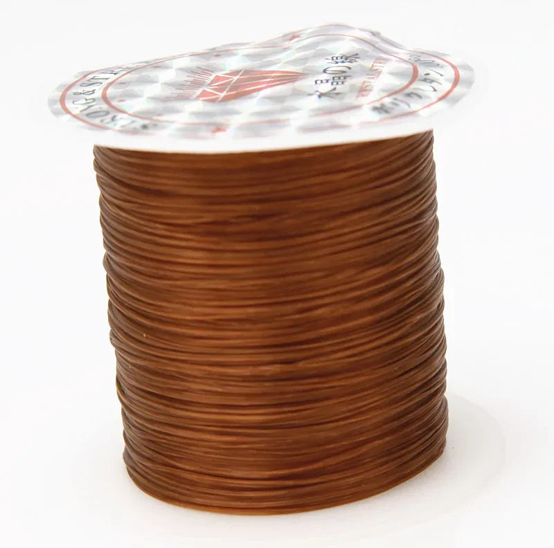 A spool of multicolor elastic beading cord with a decorative label on top.